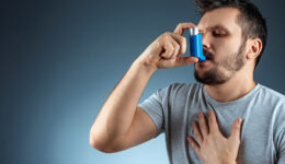 Man Using an Inhaler to Help Him Breathe During an Asthma Attack Chronic Respiratory Disease