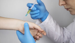 Closeup of an Arthritis Specialist Injecting a Cortisone Shot Into a Patient’s Wrist Joint Stages of Rheumatoid Arthritis